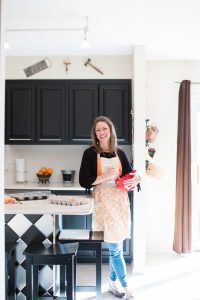 woman cooking in the kitchen stirring in a red bowl